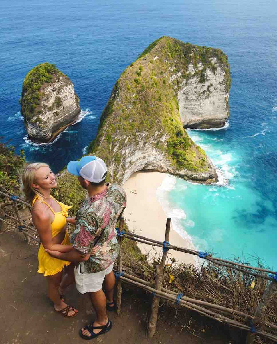 Travel couple, Cheyanne and Juan Herrera, in front of Nusa Penida in Bali.